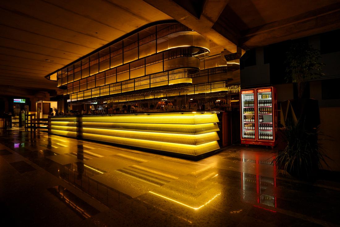 The illuminated gold brewhouse bar counter at Legacy Brewing Company
